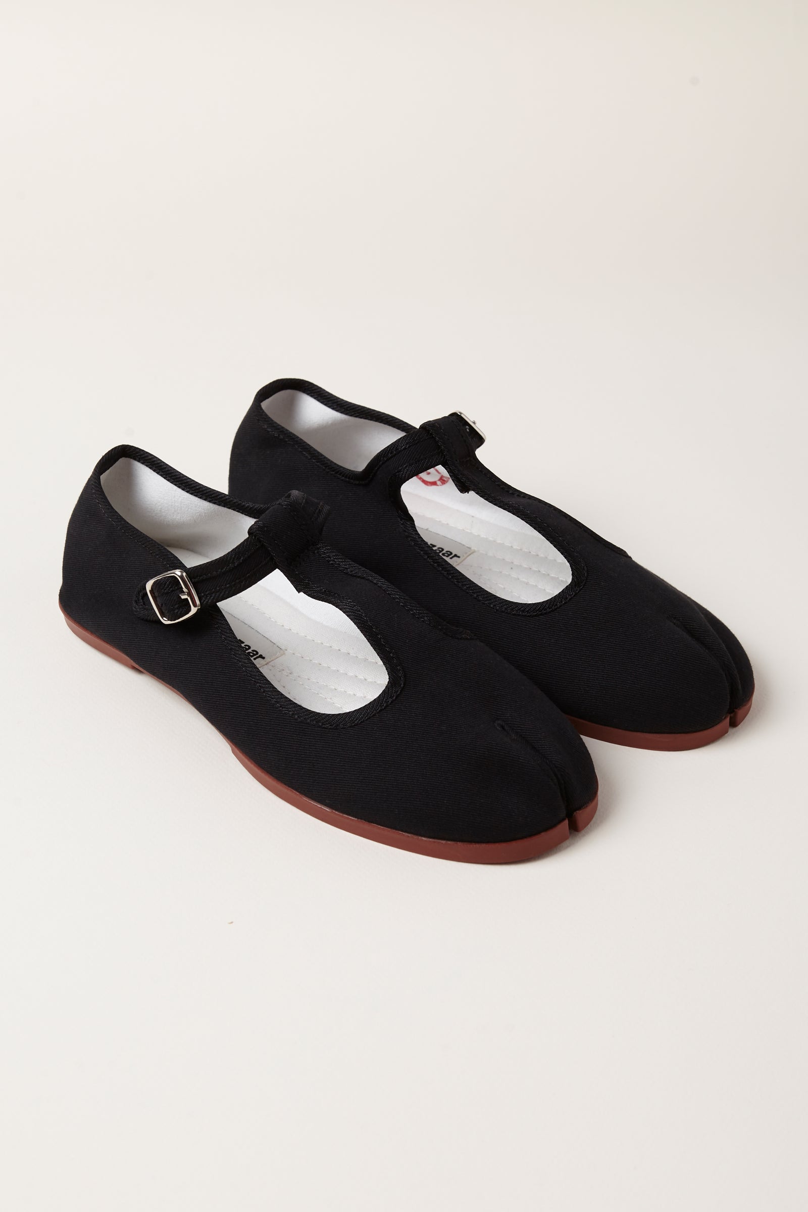 TRB#001, black tabi T-bar Mary Jane flats, three-quarter pair view on a pale background.