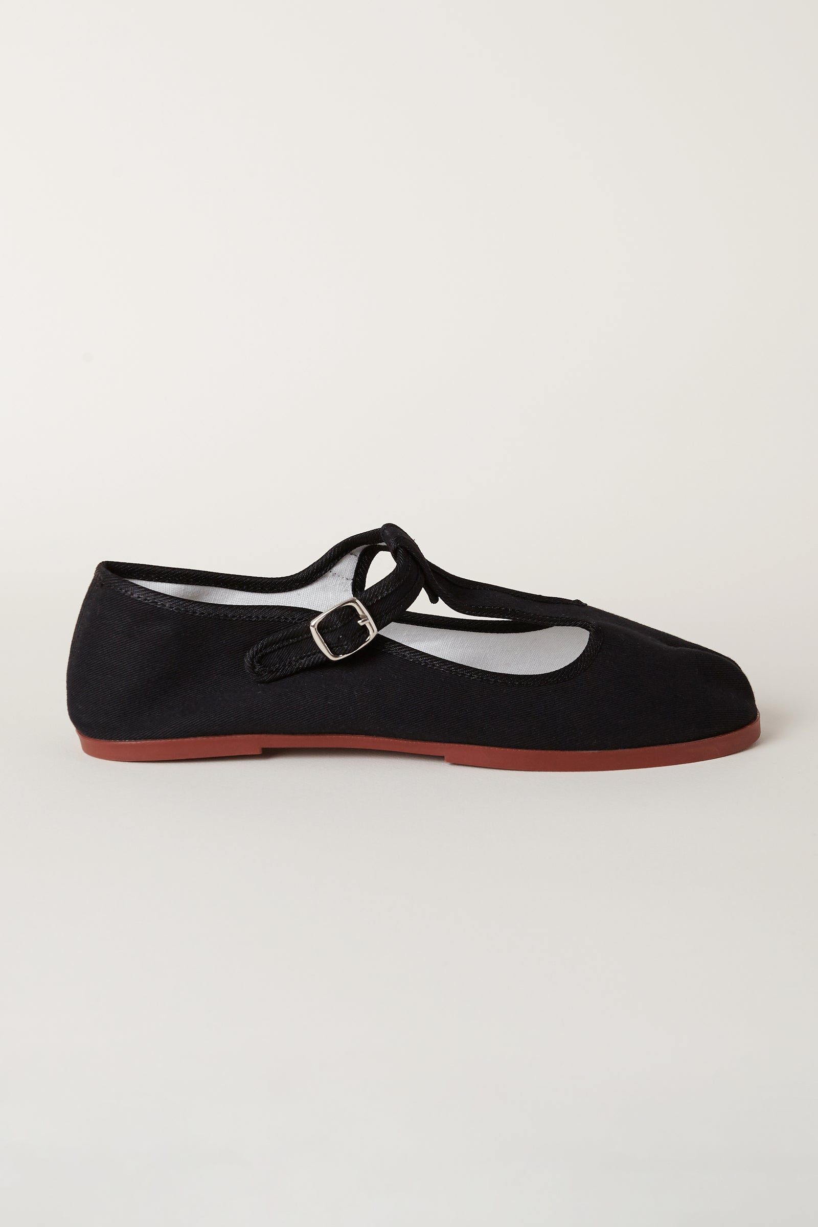 TRB#001 side profile, showing the T-bar strap, buckle and low terracotta sole.