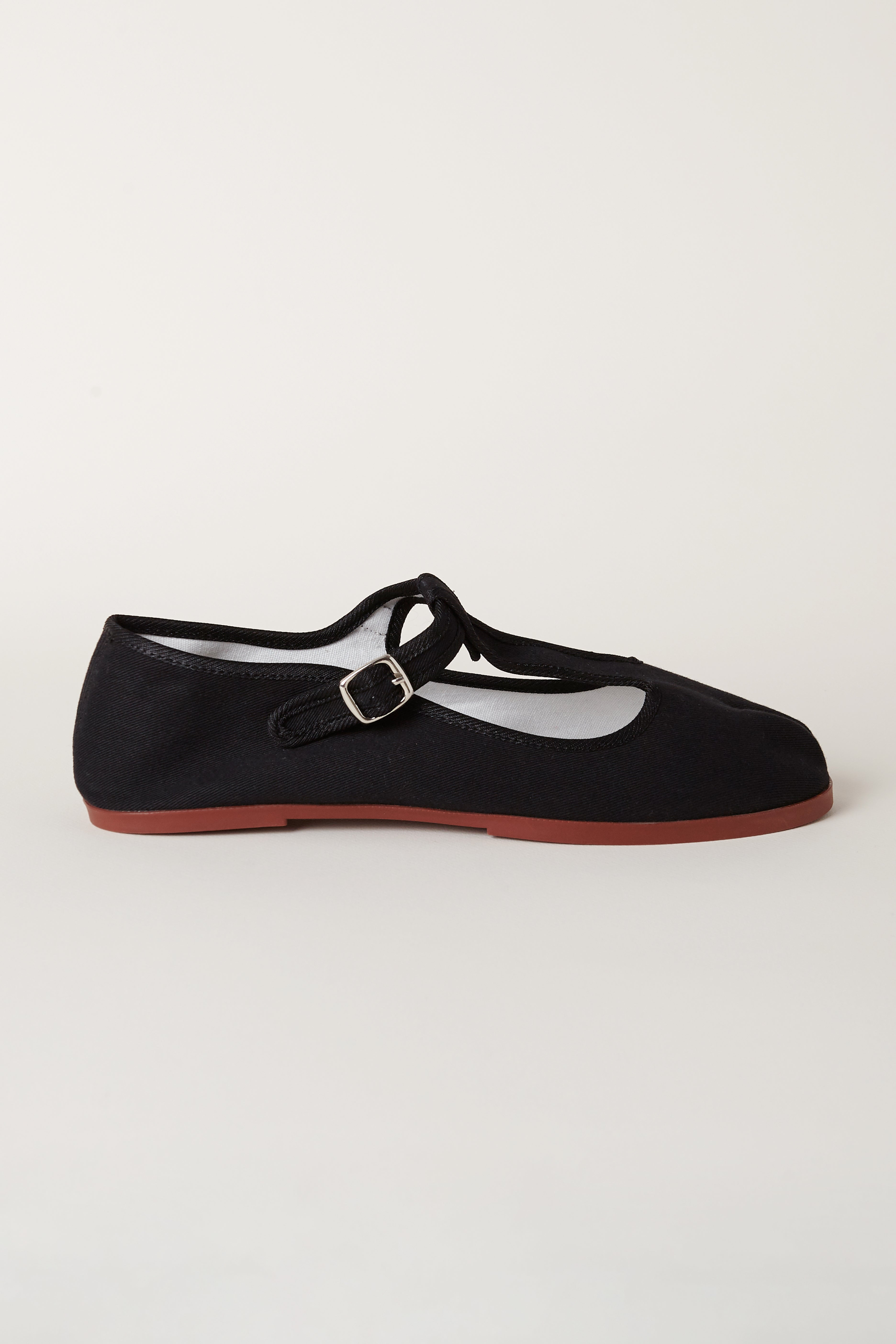 TRB#001 side profile, showing the T-bar strap, buckle and low terracotta sole.