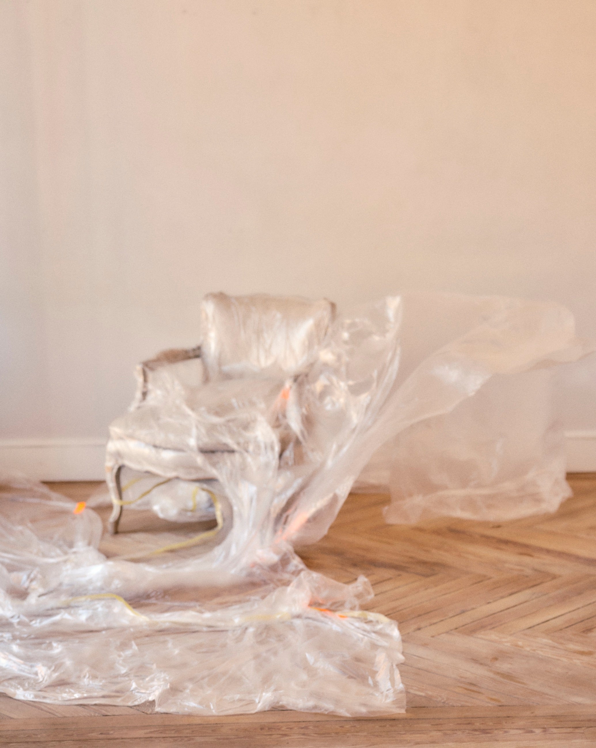 Model with legs raised against kraft paper, wearing TRB#001.